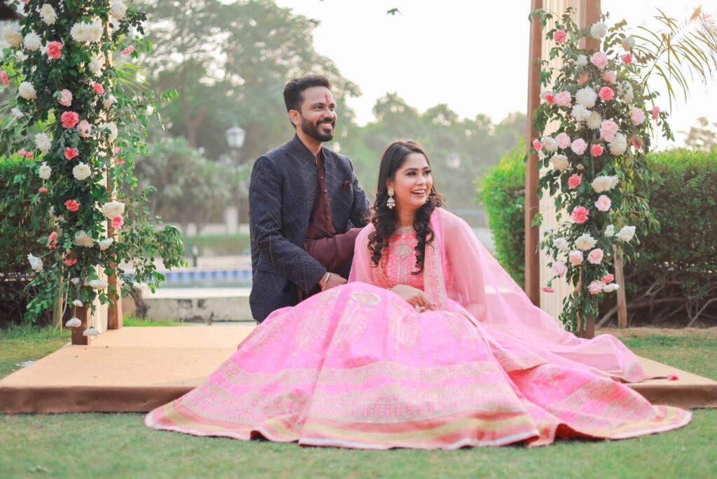 Happy bride in pink lehnga and groom in blue suit