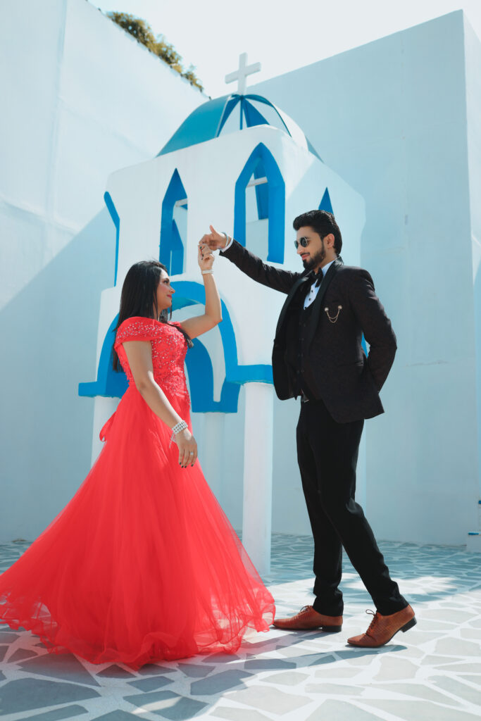 Girl in a red dress dancing with a boy in a black tuxedo