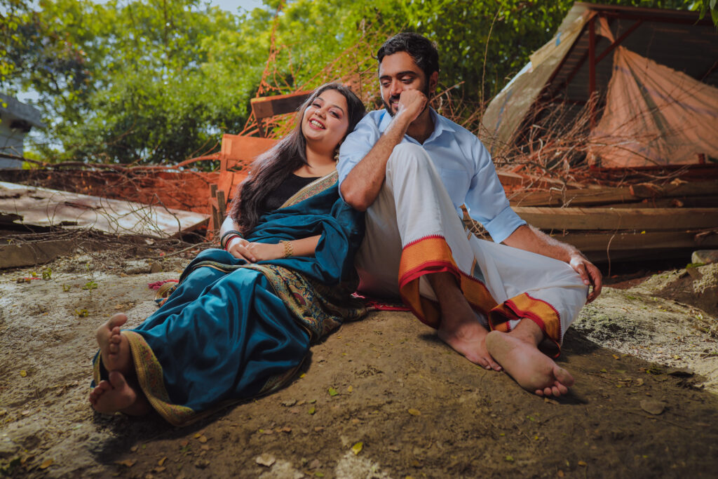 Girl in a blue saree and boy in a white dhoti sitting together