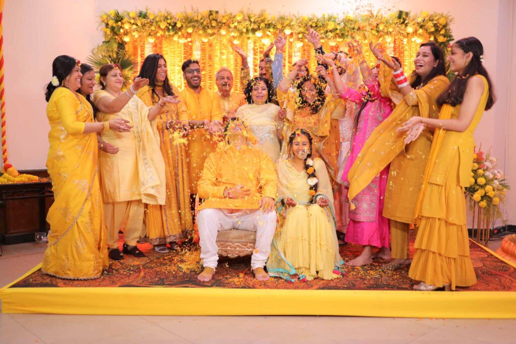 Groom and bride enjoying their haldi ceremony with family