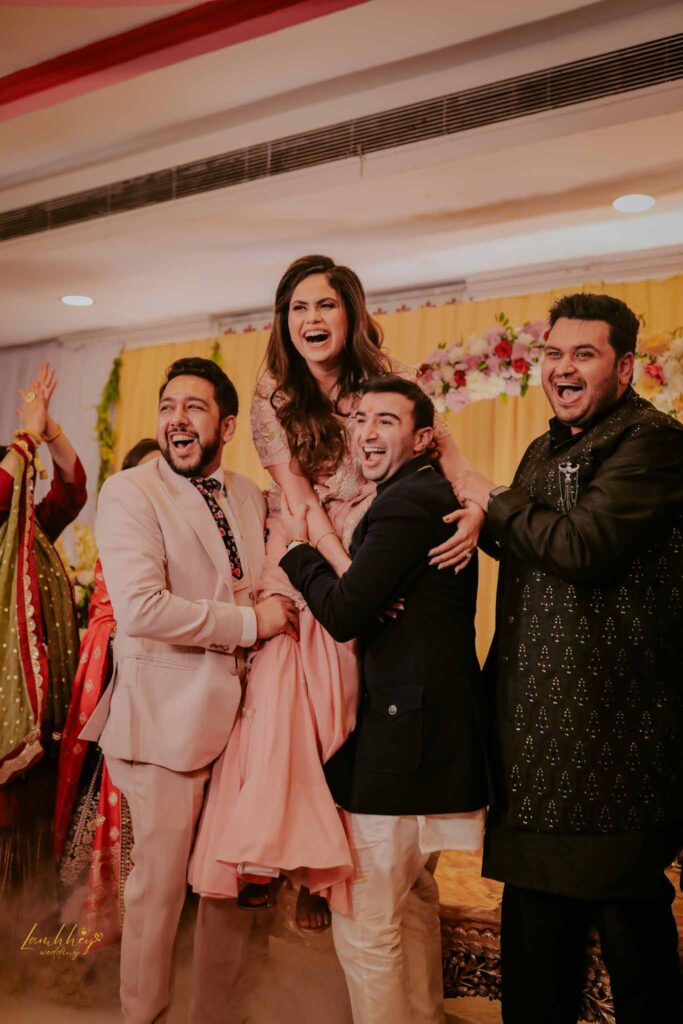 Smiling bride with her brothers on stage
