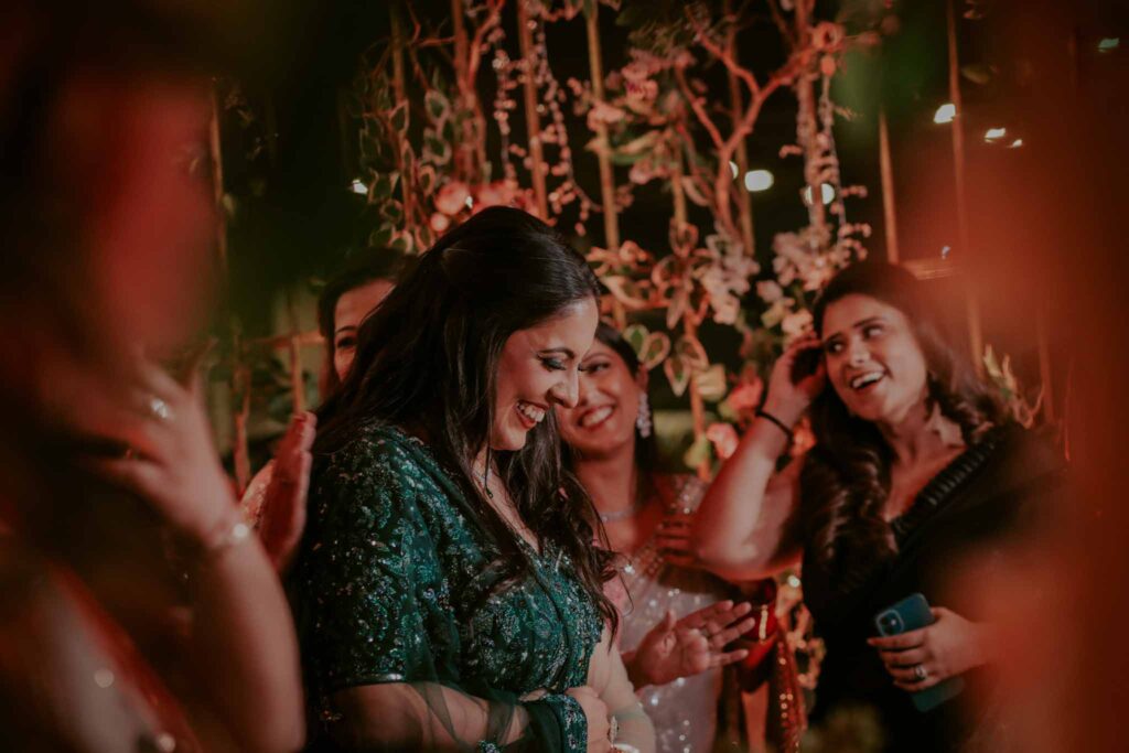 Smiling bride with her friends in green lehnga