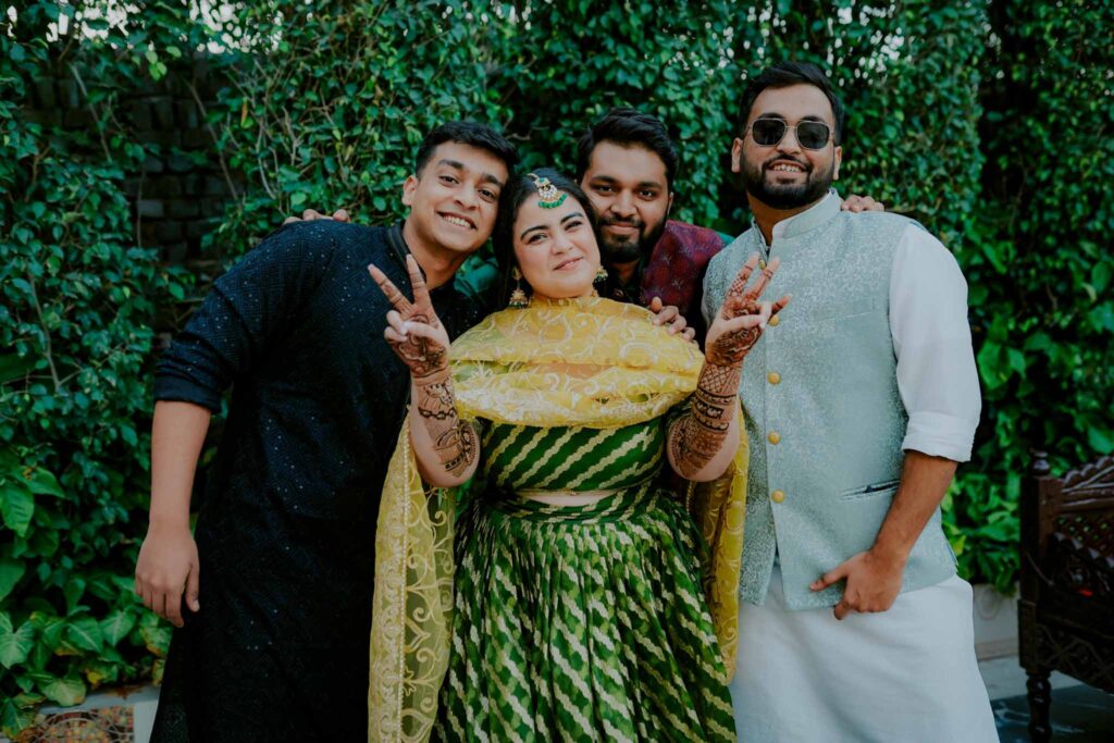 bride posing in green lehnga with friends