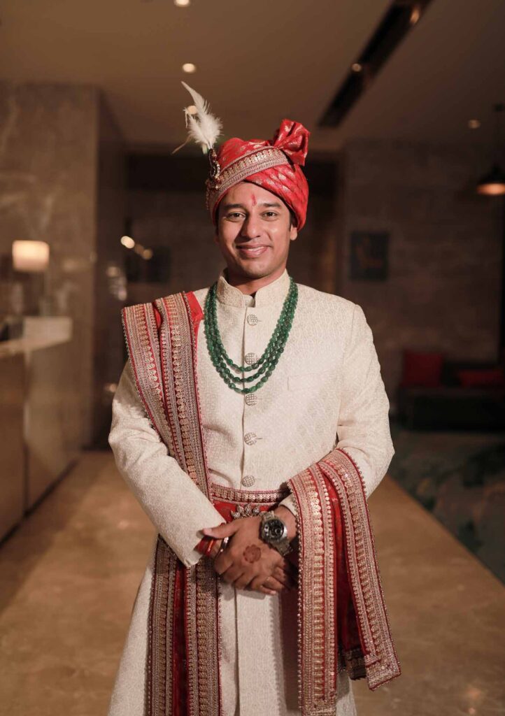 groom in white shervani