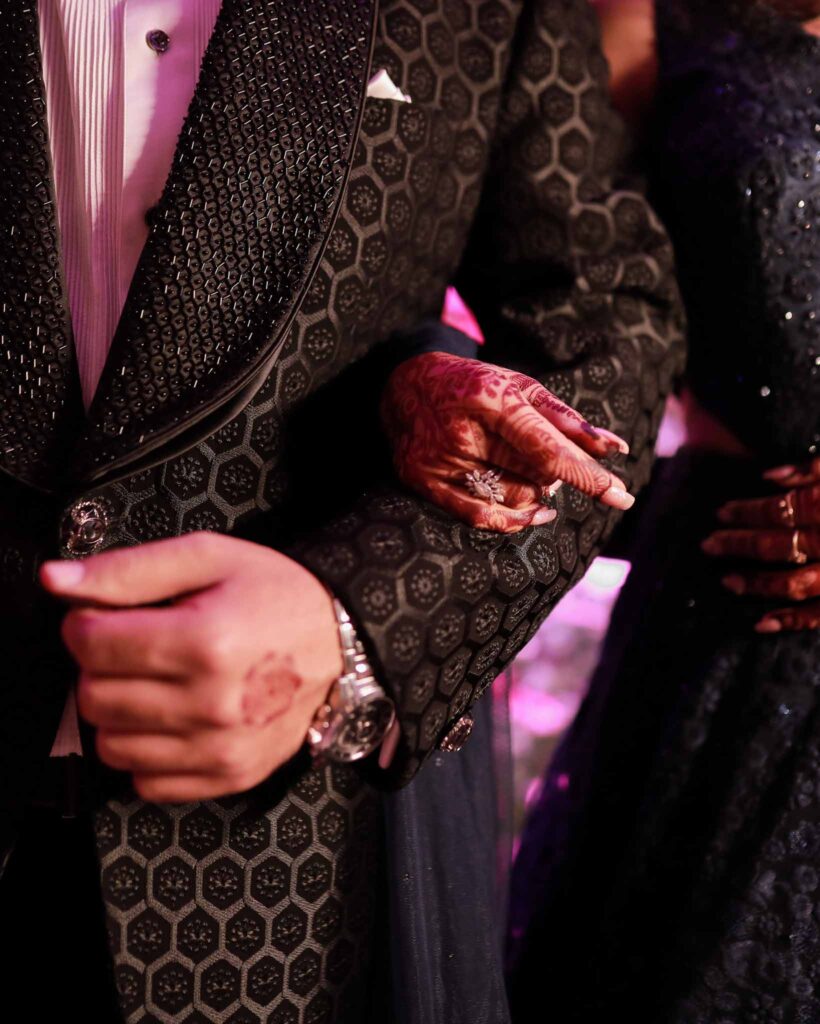 Closeup view of a bride and groom's holding hands